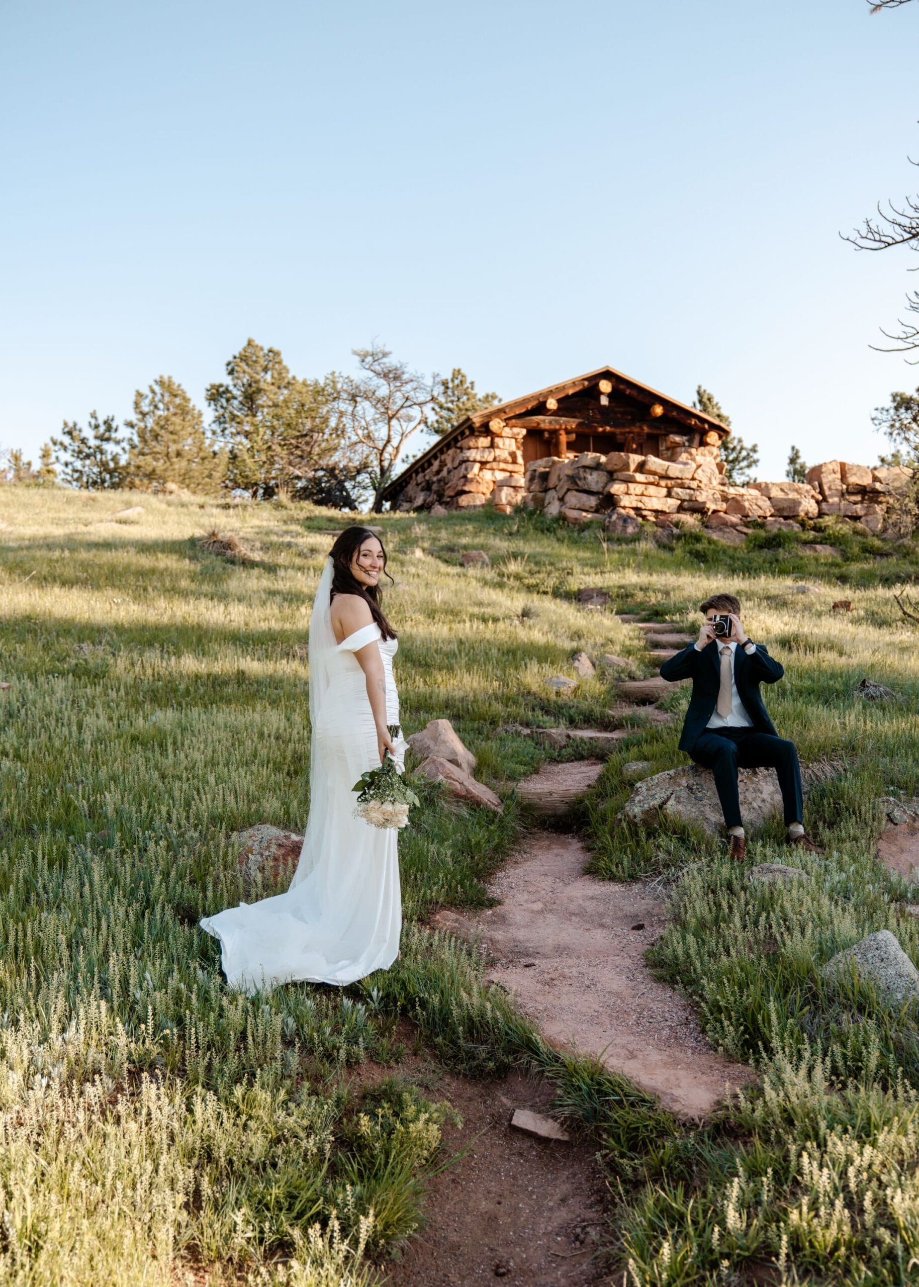 groom holding camera
